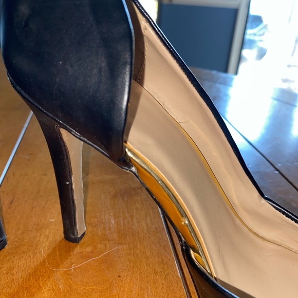 Simple black pointed toe pumps with gold detail. - Picture 2 of 6